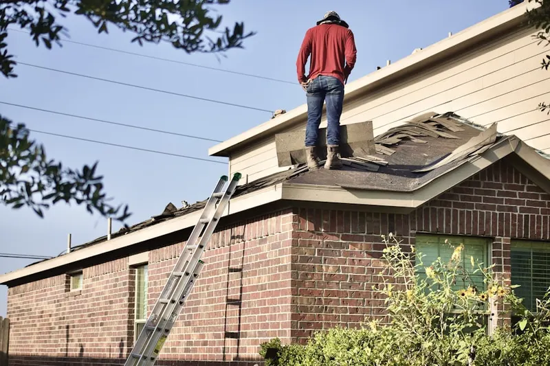 Professional roofer working on a residential roof in Southwick